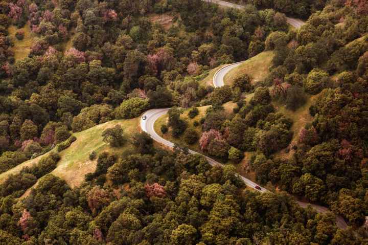 gray car on long winding road